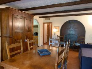 a kitchen and dining room with a wooden table and chairs at Apartment Casa delle Palme by Interhome in Marina Romea +29 photos