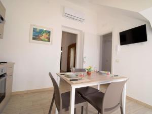 a kitchen and dining room with a table and chairs at Apartment Ginestra SinAgo by Interhome in Lascari