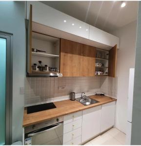 a kitchen with a sink and a counter top at Apartmani Queen in Kraljevo