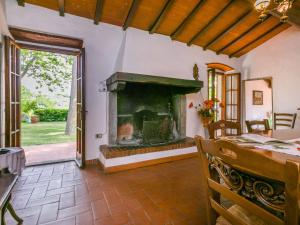 a living room with a fireplace and a dining table at Holiday Home Podere Berrettino by Interhome in Reggello
