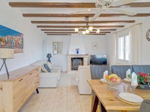 a living room with a table and chairs and a couch at Holiday Home La Repere by Interhome in Benissa