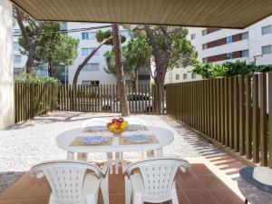 a white table and chairs on a patio at Apartment Ancora by Interhome in Platja d'Aro
