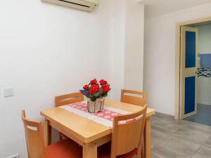 a dining room table with a vase of flowers on it at Apartment Ancora by Interhome in Platja d'Aro