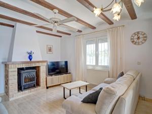 a living room with a couch and a fireplace at Holiday Home La Repere by Interhome in Benissa