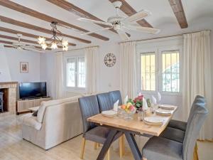 a living room with a table and a couch at Holiday Home La Repere by Interhome in Benissa