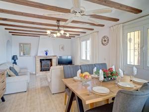 a living room with a table and chairs and a couch at Holiday Home La Repere by Interhome in Benissa +41 photos
