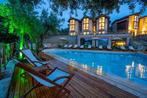 a home with a swimming pool and a house at Boho Garden Selimiye in Selimiye