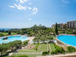 a view of the pool at a resort at Apartment Le Belvédère - V2 013 by Interhome in Agay - Saint Raphael