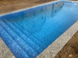 a large blue swimming pool with blue water at Fraga de Pitões in Pitões das Júnias