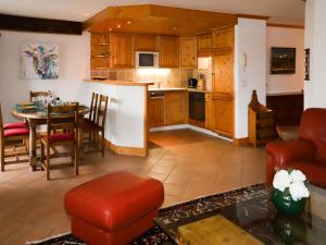 a kitchen and dining room with a table and chairs at Apartment Résidence Bristol 4 by Interhome in Villars-sur-Ollon