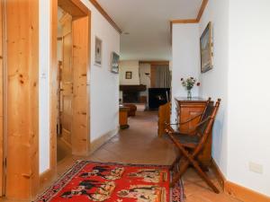 a living room with a chair and a rug at Apartment Résidence Bristol 4 by Interhome in Villars-sur-Ollon +22 photos