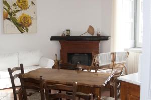 a living room with a table and chairs and a fireplace at Palazzo D'Orsi in Calvanico