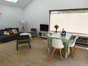 a living room with a table and chairs and a large window at La cabine du bout du monde avec Mezzanine PL04, Tevennec - votre maison de vacances de haut standing in Crozon