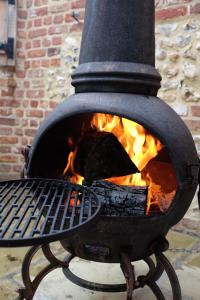 a fire inside of a fire pit with flames at The Cottages at Launceston Farm in Blandford Forum
