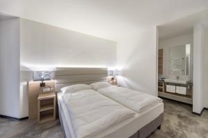 Łóżko lub łóżka w pokoju w obiekcie Hotel Matteo