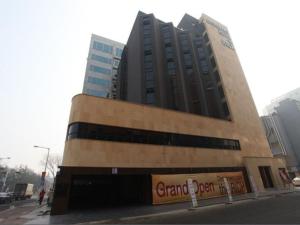 a tall building with a sign on the side of it at Hotel Rich in Goyang