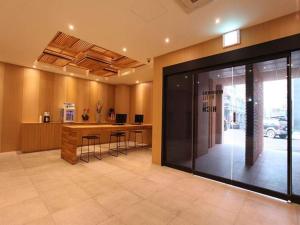 a lobby with a desk and a glass door at Hotel Rich in Goyang