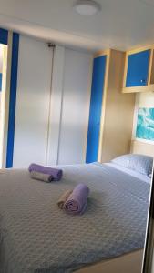 a bedroom with two purple pillows on a bed at BISER KVARNERA 1. in Mošćenička Draga +14 photos