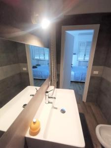 a bathroom with a white sink and a mirror at Casa Giulia a 500 mt dal mare in Montesilvano