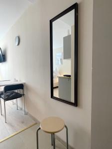 a mirror on a wall with a table and a chair at 09 Gdynia Centrum - Apartament Mieszkanie dla 2 os in Gdynia