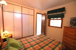 a bedroom with a bed and a dresser and a window at Vivienda Oscar in Puerto Naos