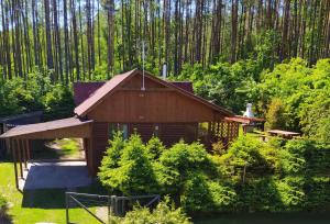 a small wooden cabin in the middle of a forest at Przylesie Trzebciny in Trzebciny