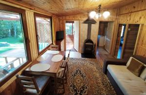a living room with a table and a wood stove at Przylesie Trzebciny in Trzebciny