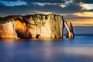 a large white cliff in the ocean with a cloudy sky at LE COTIER in Fécamp +32 photos