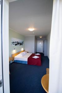 Säng eller sängar i ett rum på Hotel Promenaadi
