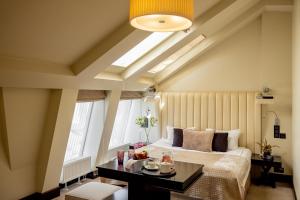 a bedroom with a large bed and a window at Astoria Hotel in Lviv