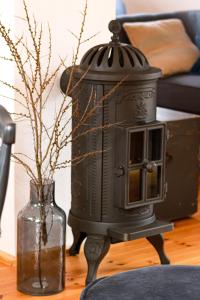 a black lantern sitting on a table next to a vase at NEU!!! Stadtnest Malchow - für 2-12 Personen in der Inselstadt - Mecklenburgische Seenplatte in Malchow