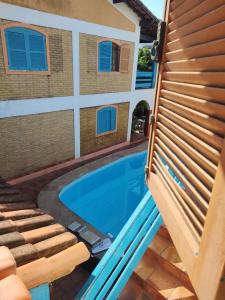 uma piscina em frente a uma casa em Aloha hostel cabo frio em Cabo Frio