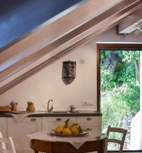 a kitchen with a table with a bowl of fruit on it at Bella Baia Relais in Maiori