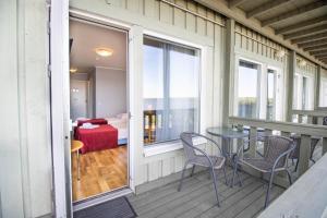 a balcony with a table and chairs and a bedroom at Hotel Promenaadi in Haapsalu