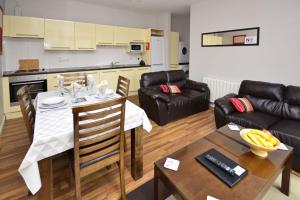 a kitchen and living room with a table and a couch at Apartment 701 - Letterfrack in Letterfrack