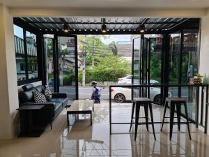 a living room with a couch and some stools at ก้านกล้วยแมนชั่น Gankluy Mansion in Phuket