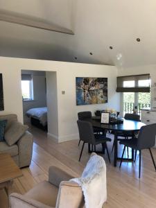 a living room with a table and a dining room at The Loft in Crowborough