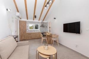 a living room with a couch and a table at Apartments Grey, Green i White in Malinska