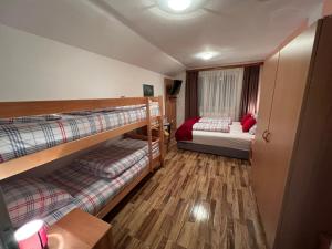 a room with two bunk beds and a bed at Hotel Central Vlašić in Vlasic