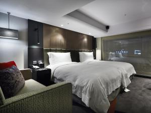 Rúm í herbergi á The Tango Hotel Taipei FuHsing