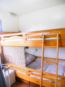 a bunk bed with a ladder in a room at Palette Takashimadaira guest house in Tokyo