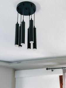 a black chandelier hanging from a ceiling at Siblings Apartments in Nikiti