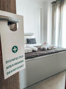 a bed with a sign that reads discharged emergencyiation department at Siblings Apartments in Nikiti