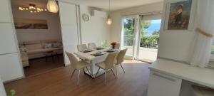 a dining room with a table and chairs in a room at Apartment Sunrise, Polje - otok Krk in Polje +18 photos