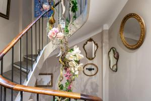 a spiral staircase with flowers on the wall at Hotel l'Hotera in Cannes