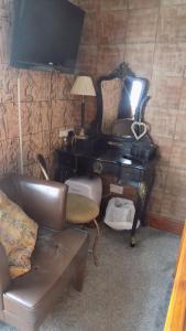 a living room with a piano and a couch at Tracey's Driftwood in Blackpool