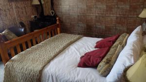 a wooden bed with pillows on it in a room at Tracey's Driftwood in Blackpool