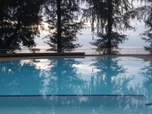 a swimming pool with trees in the background at Sandy Beach E18 in Cha Am