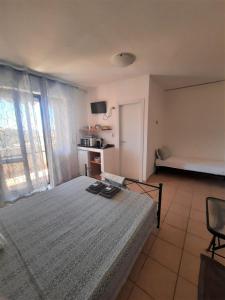 a bedroom with a large bed and a window at White Beach in Alghero