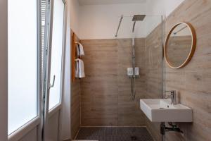 a bathroom with a sink and a mirror at Hotel l'Hotera in Cannes